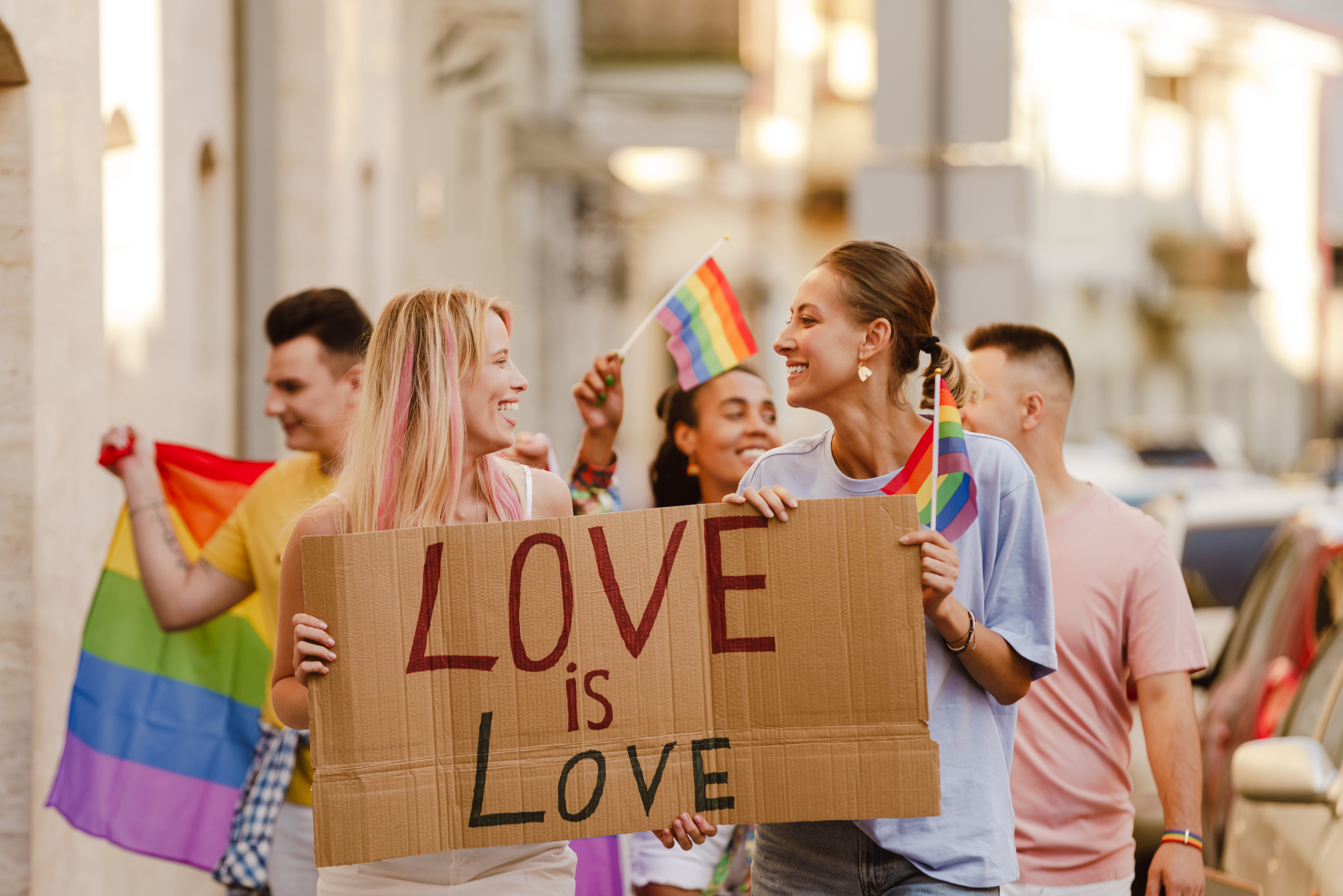 young-lesbian-couple-walking-with-placard-during-p-2022-04-15-20-57-16-utc